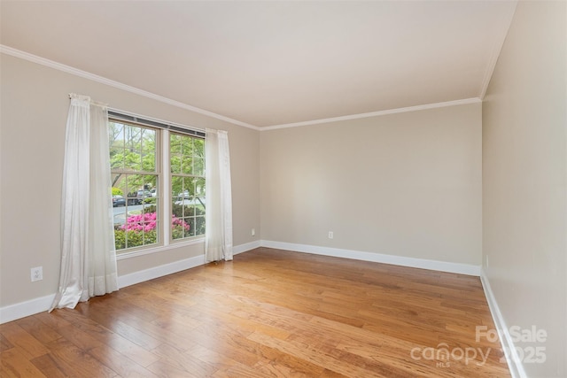 unfurnished room featuring baseboards, light wood-style flooring, and crown molding