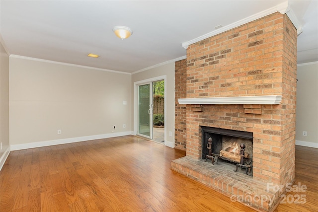 unfurnished living room with baseboards, wood finished floors, ornamental molding, and a brick fireplace