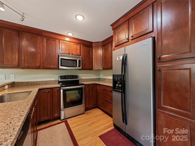 234 Bird Creek Dr, Waynesville, NC 28786 - kitchen featuring stainless steel appliances, light wood finished floors, recessed lighting, light stone counters, and a textured ceiling