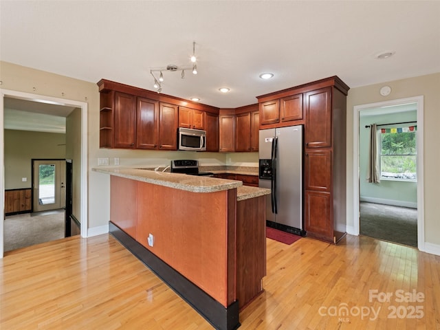 234 Bird Creek Dr, Waynesville, NC 28786 - kitchen with stainless steel appliances, a peninsula, light wood-style flooring, open shelves, and light countertops