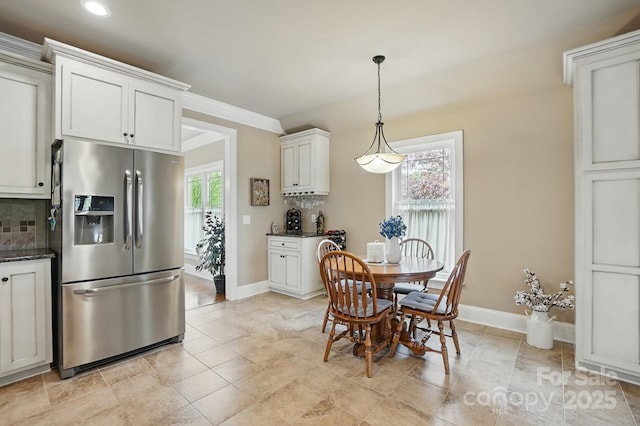 dining room featuring baseboards and recessed lighting