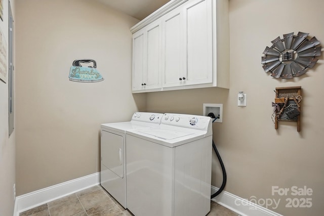 laundry area featuring baseboards, washer and clothes dryer, and cabinet space