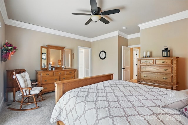 carpeted bedroom featuring a ceiling fan, baseboards, and crown molding