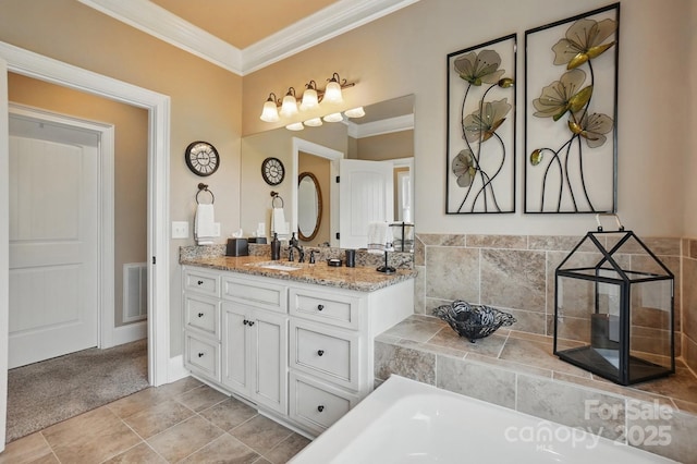 full bath with crown molding, vanity, a bathtub, and visible vents