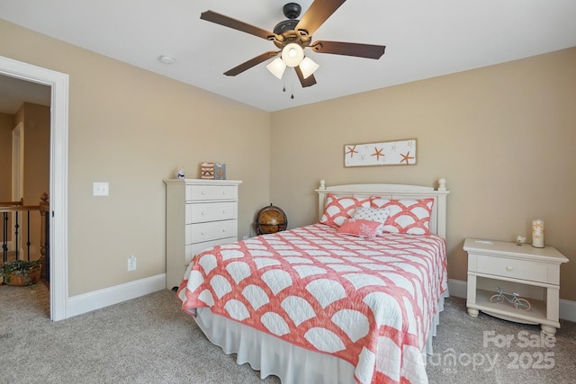 carpeted bedroom with ceiling fan and baseboards
