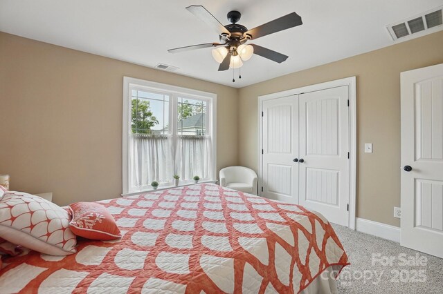 carpeted bedroom with baseboards, a ceiling fan, visible vents, and a closet