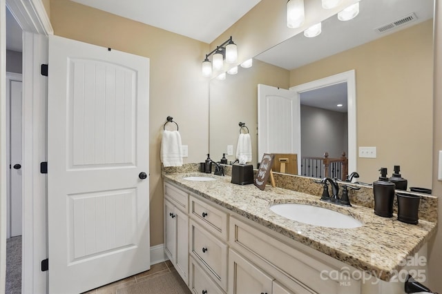 bathroom with tile patterned flooring, visible vents, a sink, and double vanity
