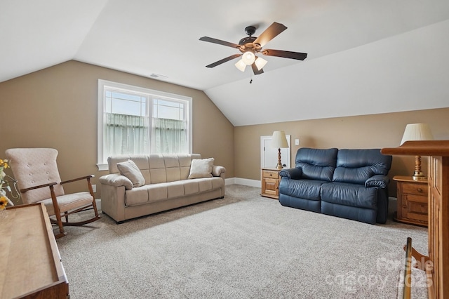 carpeted living area with lofted ceiling, baseboards, visible vents, and ceiling fan