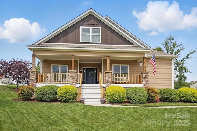 craftsman house featuring board and batten siding, roof with shingles, a porch, and a front lawn