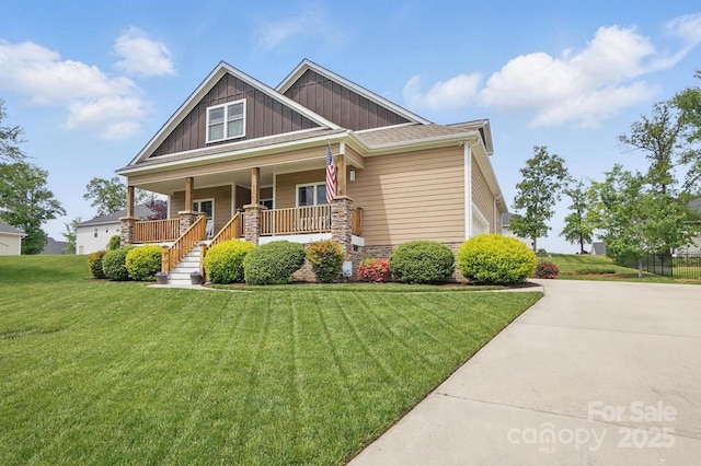 craftsman house with a porch, board and batten siding, and a front yard