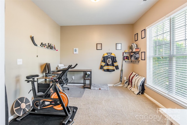 workout room featuring carpet flooring and baseboards
