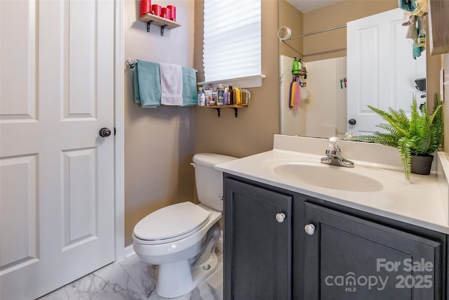 full bath with toilet, vanity, marble finish floor, and a shower