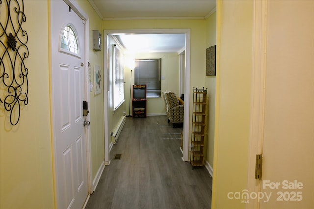 hall featuring ornamental molding, visible vents, baseboard heating, and dark wood finished floors