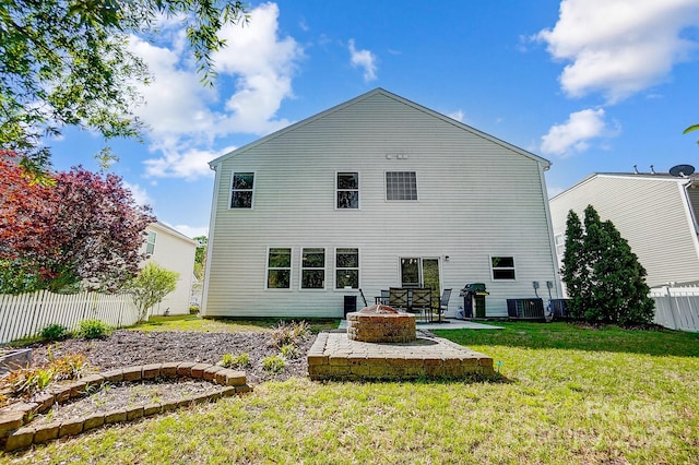 517 Bertram Rd, Fort Mill, SC 29708 - back of property featuring central air condition unit, a patio area, an outdoor fire pit, a yard, and fence