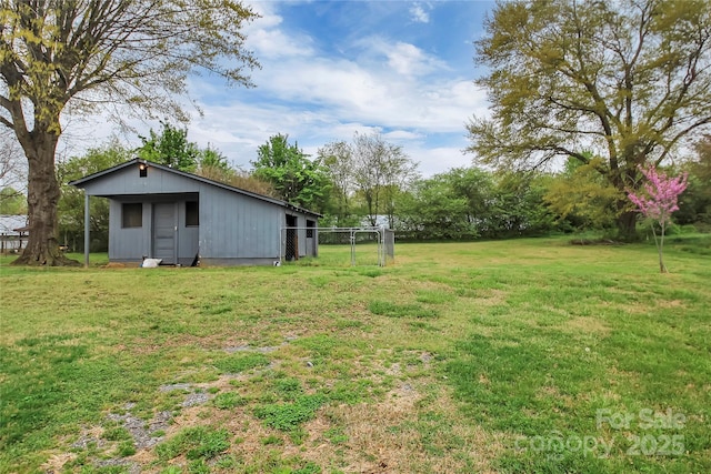 view of yard with an outbuilding and fence