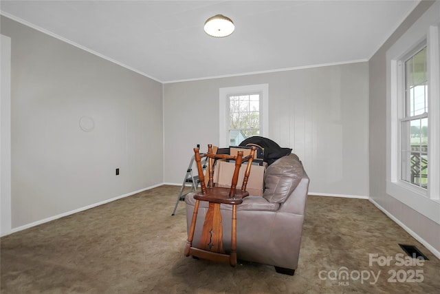 living area featuring baseboards, visible vents, crown molding, and carpet
