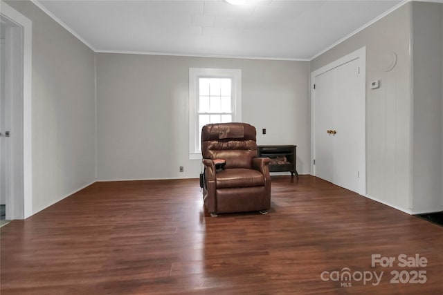 sitting room featuring wood finished floors and crown molding