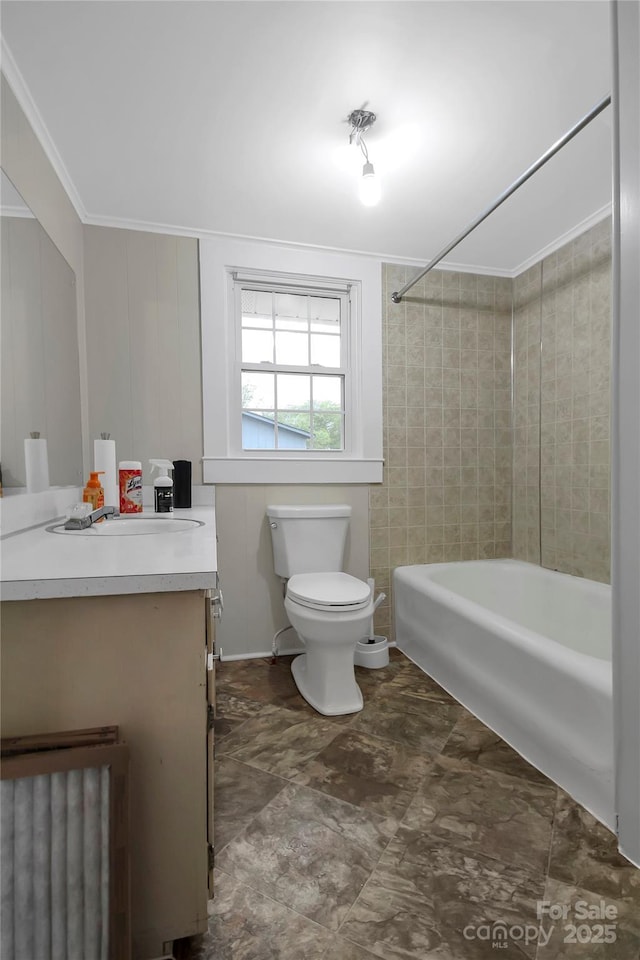 bathroom with toilet, vanity, crown molding, and washtub / shower combination