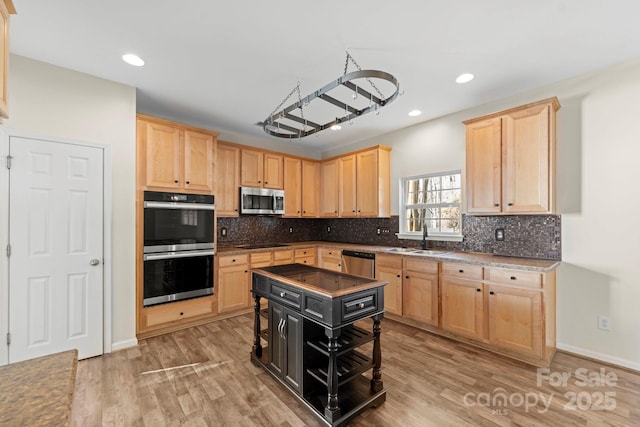 15814 Herring Gull Way, Charlotte, NC 28278 - kitchen with a sink, stainless steel appliances, light wood-style floors, and light brown cabinetry
