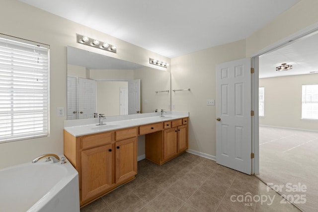 15814 Herring Gull Way, Charlotte, NC 28278 - bathroom featuring a bath, double vanity, a sink, and baseboards