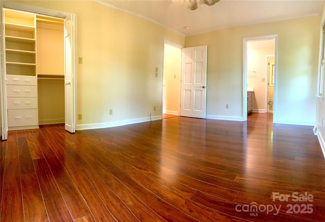 unfurnished bedroom featuring dark wood-type flooring and baseboards