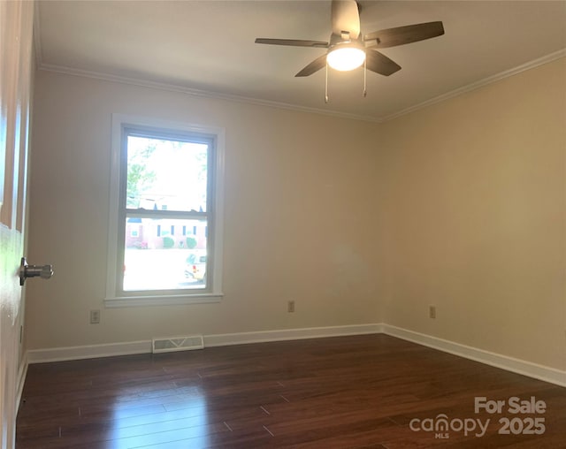 unfurnished room featuring ceiling fan, baseboards, crown molding, and dark wood-style floors