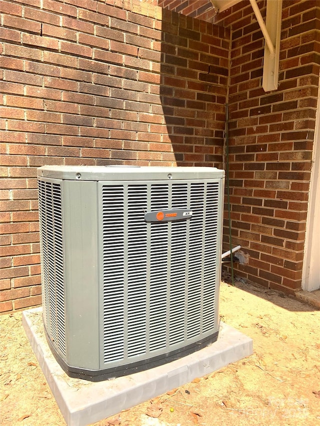 exterior details with brick siding and cooling unit