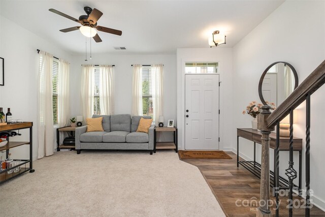 living room featuring ceiling fan and carpet flooring