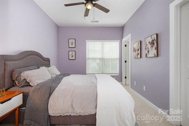 bedroom featuring light colored carpet, ceiling fan, and baseboards