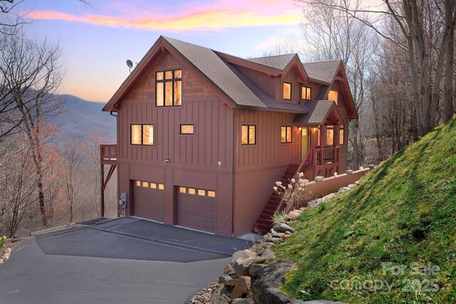 35 Great Aspen Way, Black Mountain, NC 28711 - rustic home with roof with shingles, an attached garage, driveway, stairs, and a mountain view