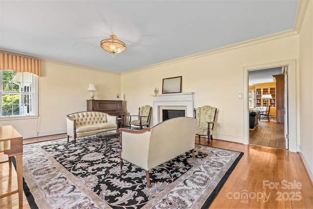 1233 General Hoke Dr, Lincolnton, NC 28092 - living area with ornamental molding, baseboards, hardwood / wood-style flooring, and a fireplace