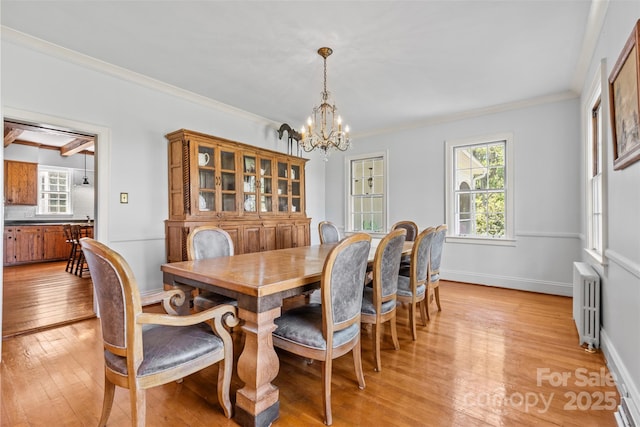1233 General Hoke Dr, Lincolnton, NC 28092 - dining area featuring light wood-style flooring, radiator, an inviting chandelier, and a wealth of natural light