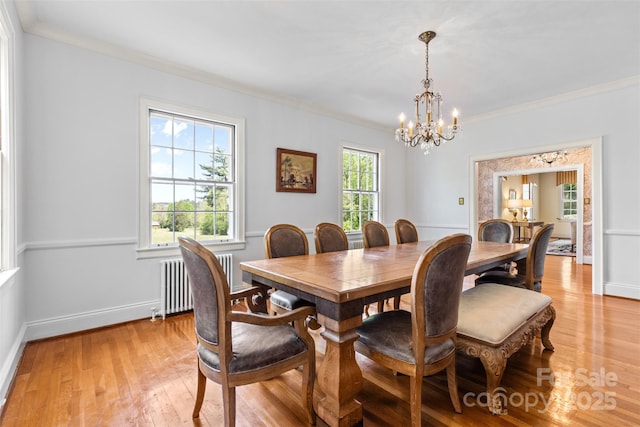 1233 General Hoke Dr, Lincolnton, NC 28092 - dining space featuring baseboards, light wood-type flooring, ornamental molding, a chandelier, and radiator