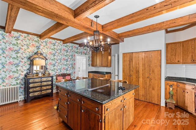 1233 General Hoke Dr, Lincolnton, NC 28092 - kitchen with radiator heating unit, light wood-style floors, black electric stovetop, and wallpapered walls