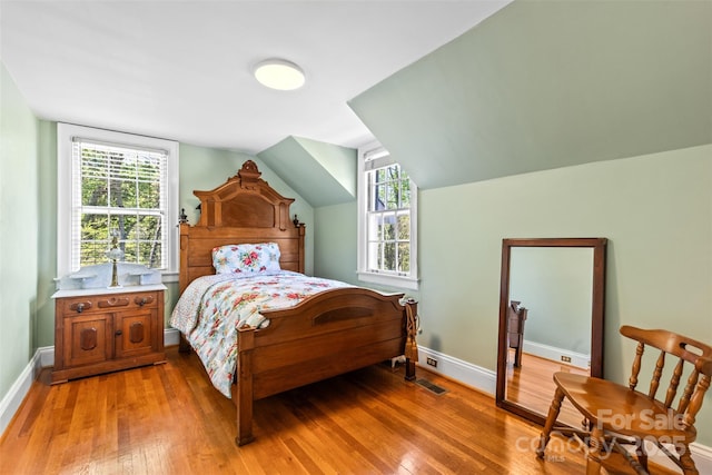 1233 General Hoke Dr, Lincolnton, NC 28092 - bedroom with light wood-type flooring, baseboards, and lofted ceiling
