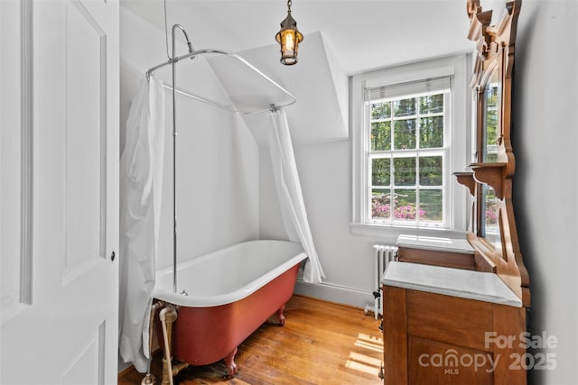 1233 General Hoke Dr, Lincolnton, NC 28092 - full bath featuring baseboards, a shower with curtain, a tub to relax in, radiator, and wood finished floors