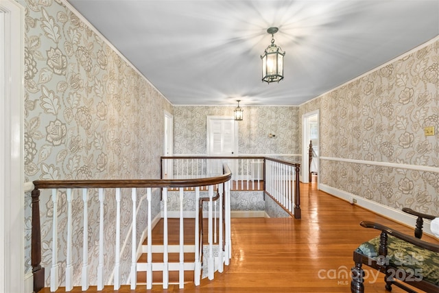1233 General Hoke Dr, Lincolnton, NC 28092 - interior space featuring crown molding, wallpapered walls, wood finished floors, and an upstairs landing