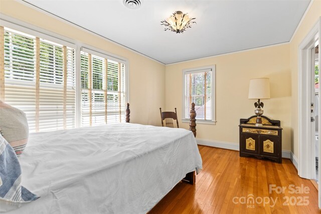 1233 General Hoke Dr, Lincolnton, NC 28092 - bedroom featuring baseboards, multiple windows, visible vents, and hardwood / wood-style flooring