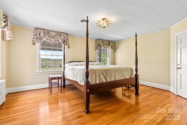 1233 General Hoke Dr, Lincolnton, NC 28092 - bedroom with light wood-style flooring, crown molding, radiator heating unit, and baseboards