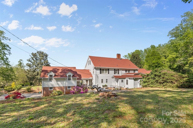 1233 General Hoke Dr, Lincolnton, NC 28092 - rear view of property featuring a chimney and a lawn