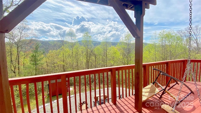 wooden deck with a view of trees