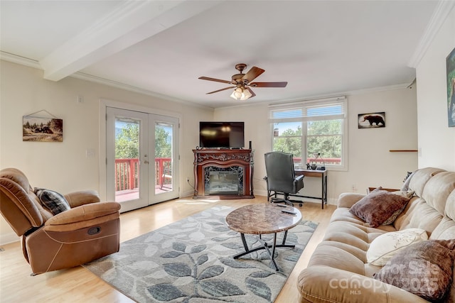 living area with light wood-style floors, crown molding, and a healthy amount of sunlight