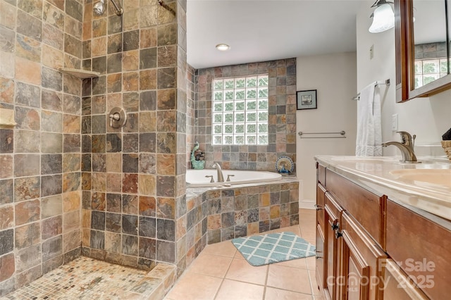 bathroom with tile patterned floors, a tile shower, vanity, and a garden tub