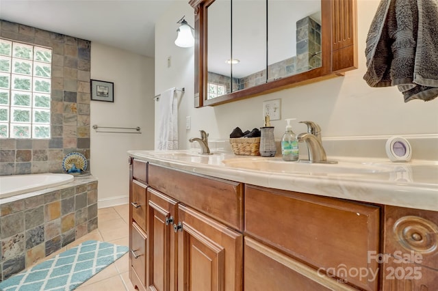 bathroom with tile patterned floors, double vanity, a bath, and a sink
