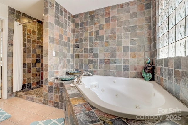 full bath featuring a jetted tub, tile walls, and a tile shower