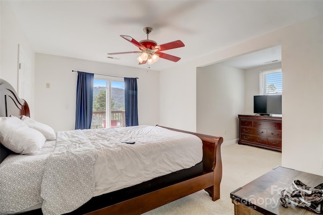bedroom featuring access to outside, carpet, visible vents, and multiple windows