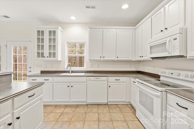 kitchen with white appliances, white cabinetry, visible vents, recessed lighting, and a sink