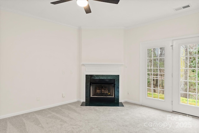 unfurnished living room featuring carpet flooring, visible vents, ornamental molding, and a ceiling fan