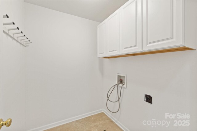 washroom featuring electric dryer hookup, baseboards, hookup for a washing machine, and cabinet space