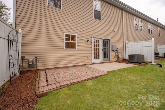 back of property with central AC, fence, a patio, and a lawn